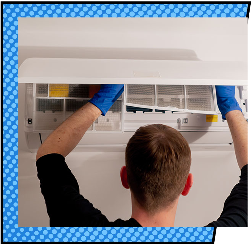 HVAC technician cleaning an AC filter during air conditioning maintenance in Coweta County