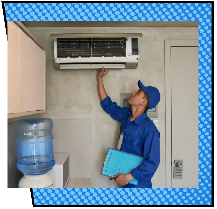 Technician in blue uniform inspects a wall-mounted air conditioner, holding documents. A water cooler is nearby, suggesting an office setting.